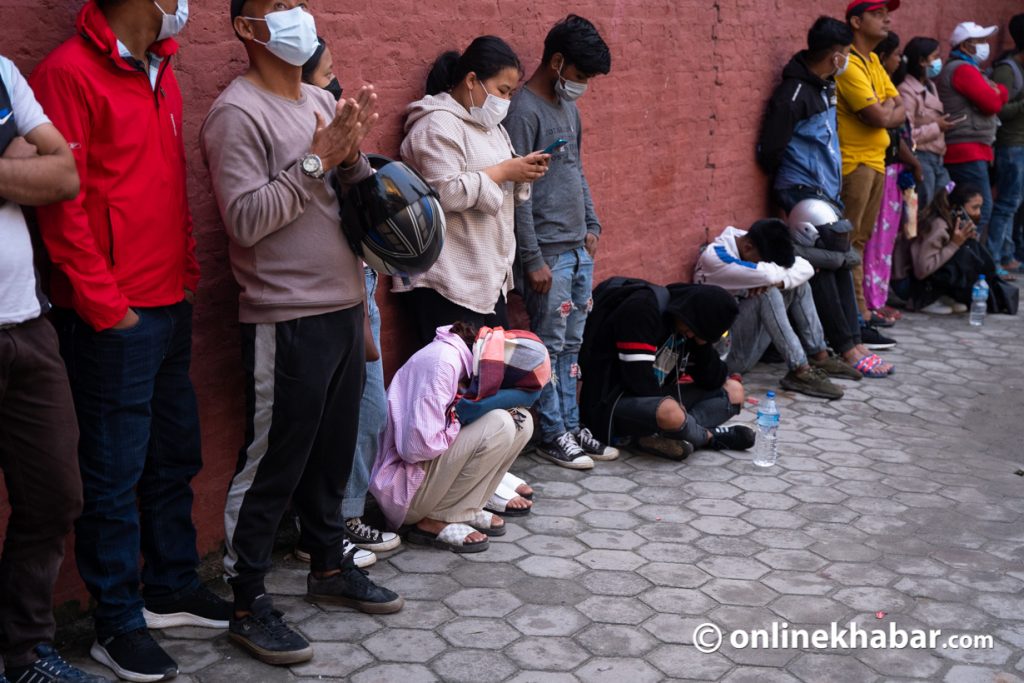 Service seekers stands in queue for national ID card, outside the department of passport.
