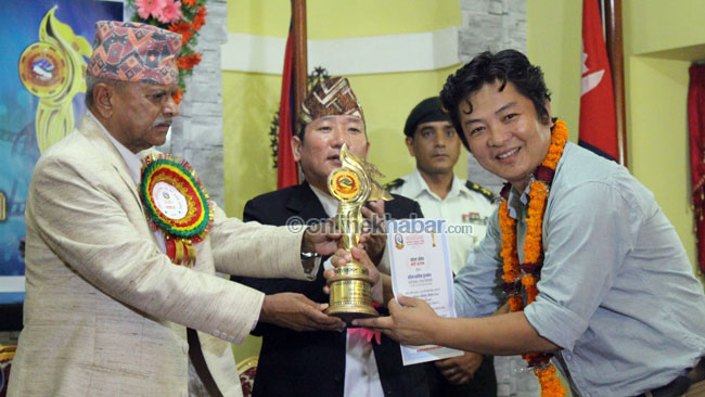 Dayahang Rai receiving award. 