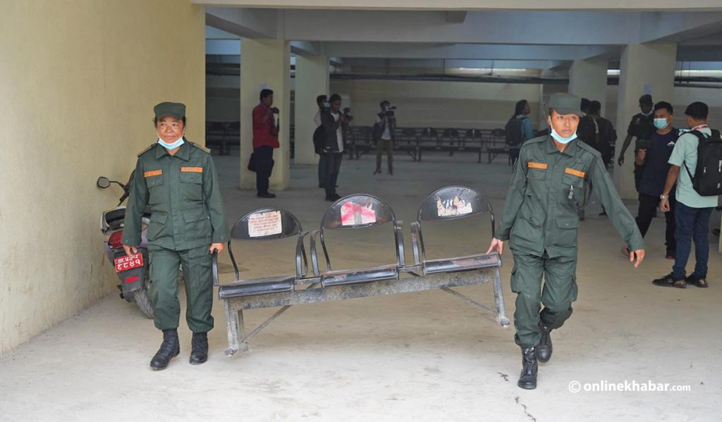 Kathmandu metropolitan city's police personnel remove chairs from the basement of the Department of Passports office to ensure underground parking, on Friday, August 26, 2022. Photo: Chandra Bahadur Ale