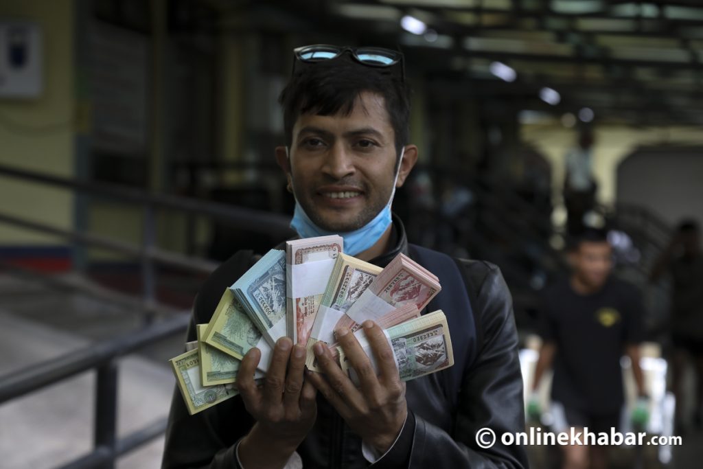 A man gets new banknotes for Dashain, in Kathmandu, on Wednesday, September 14, 2022. Photo: Shankar Giri