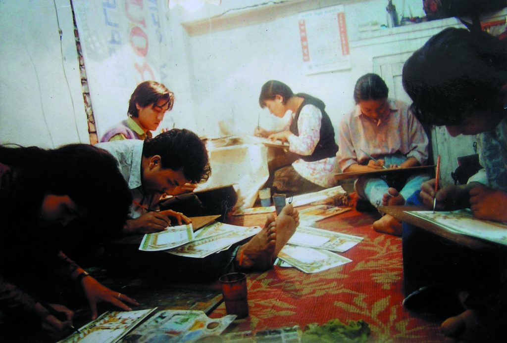 Artist Binod Pradhan working on making cards in 1994 at Pyukha, Kathmandu.