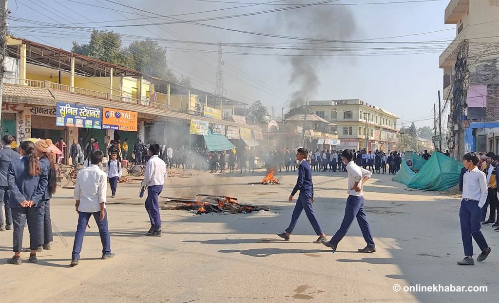 Locals obstruct a road and stage a protest after the death of a schoolgirl hit by a heavy equipment tool, in Dhangadhi of Kailali, on Thursday, December 1, 2022. 
