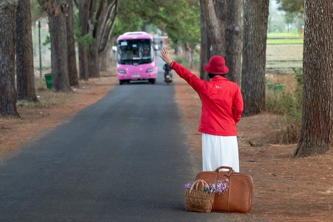 woman stopping bus to use public transport 