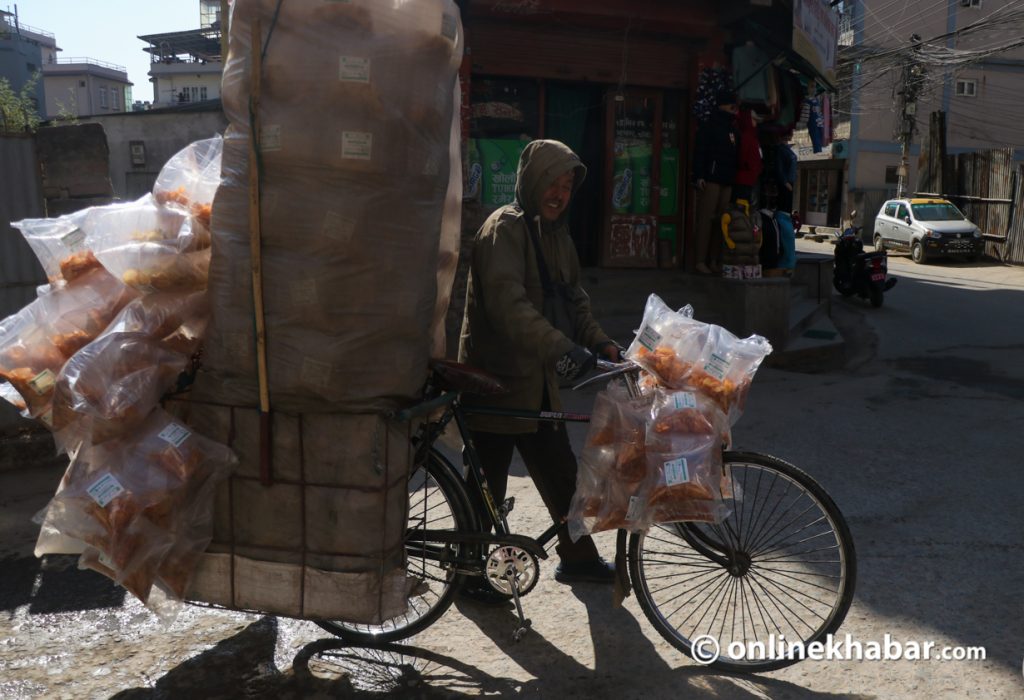 Street vendor Gyan Bahadur Shrestha sells potato chips on his bicycle.  Photo: Aryan Dhimal