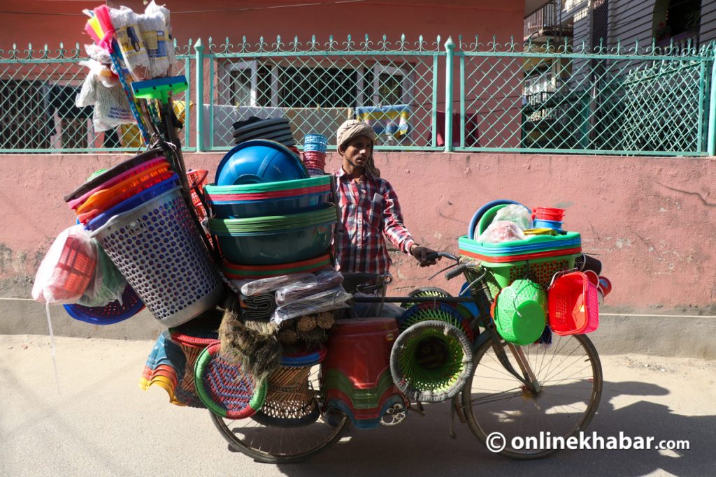 Street vendor Tej Yadav of Siraha sells plastic utensils in Kathmandu. Photo: Aryan Dhimal
