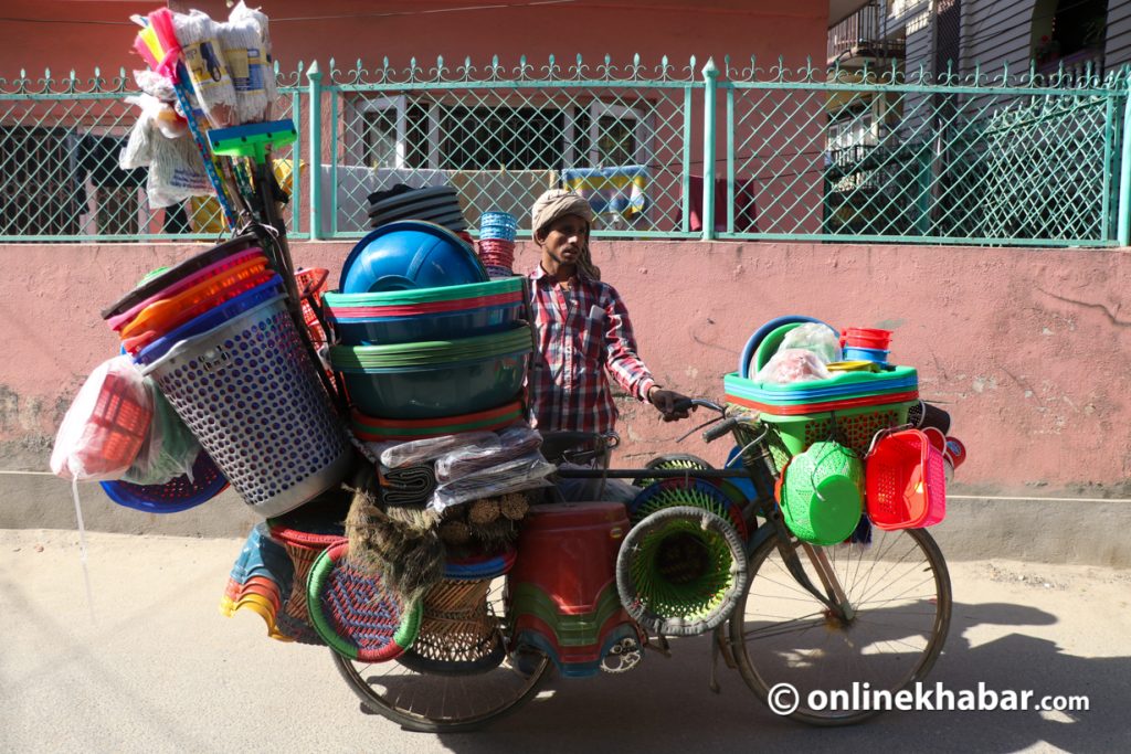 Street vendor Tej Yadav of Siraha sells plastic utensils in Kathmandu.  Photo: Aryan Dhimal