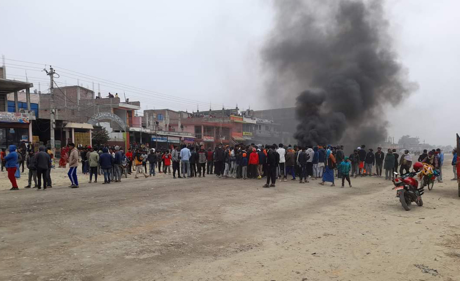 Students block the East-West Highway to stage a protest after the death of their friend, after drinking spirit given by her teacher mistakenly, in Mirchaiya, Siraha, on Sunday, January 8, 2022. 