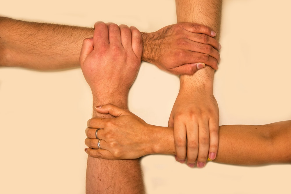 hands joined together about social protection