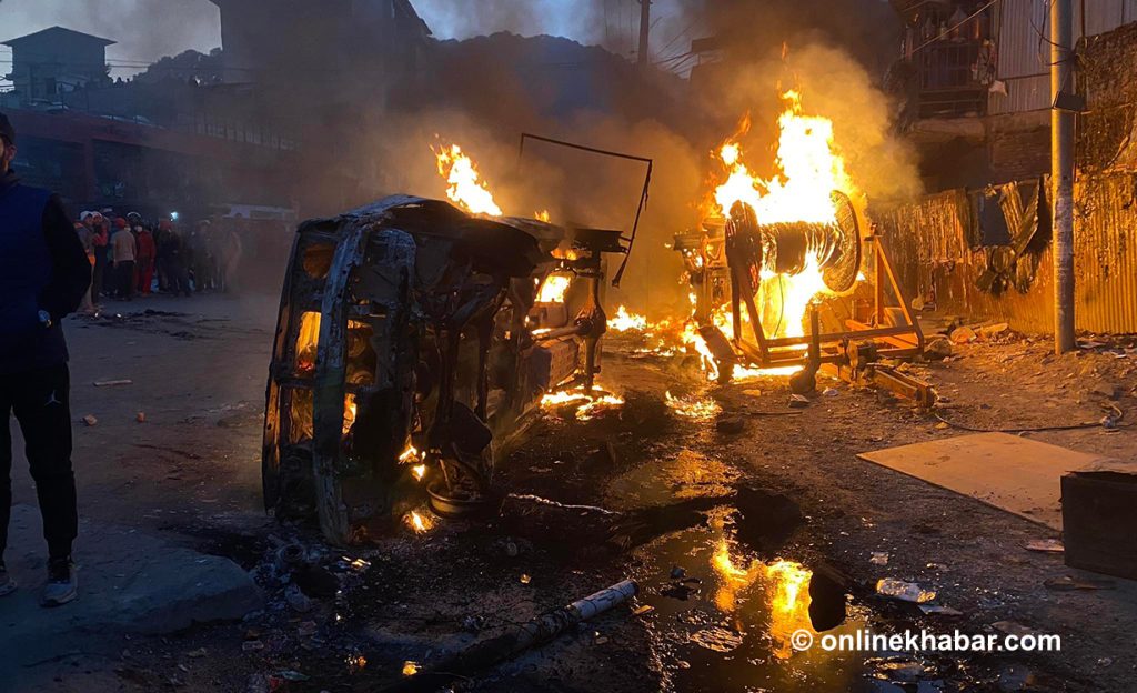 Protesters set fire to two police vans. Photo: Chandra Bahadur Ale