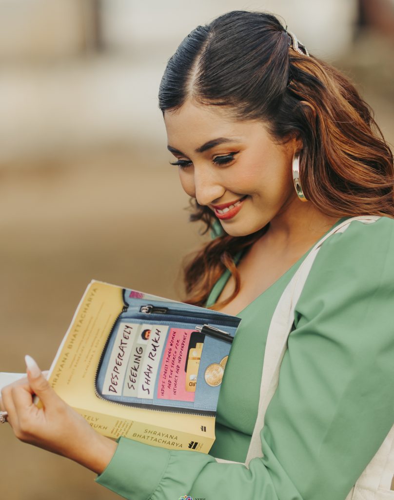 Actor Aanchal Sharma, also the brand ambassador of Parachute Naturale shampoo, with Shrayana Bhattacharya's book, Desperately Seeking Shah Rukh. Photo: Nepal Literature Festival