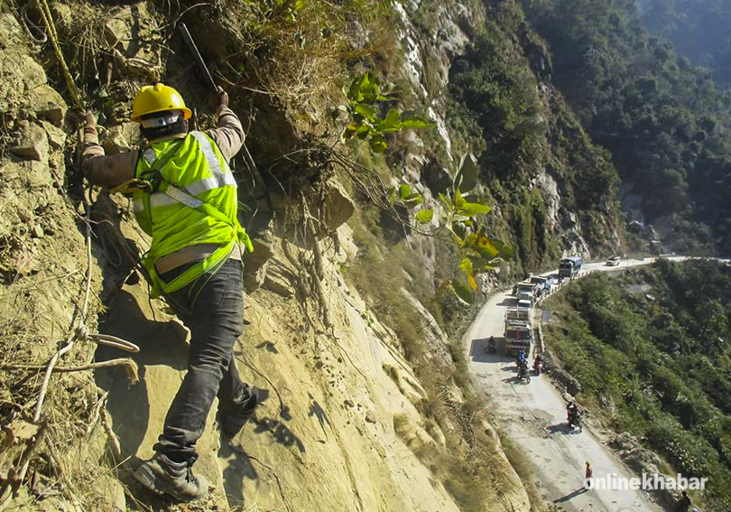File: A man works to prevent landslides on the Siddhababa section of the Butwal-Palpa road, in Lumbini. 