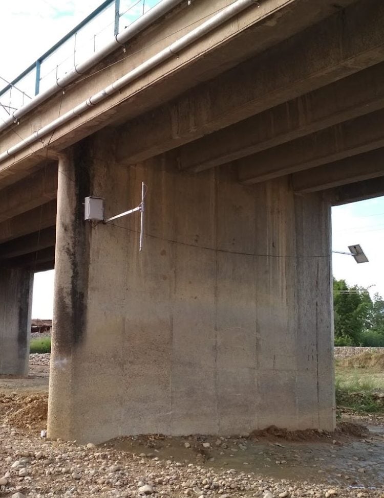 A sensor installed on a bridge over the Ratu river in southern Nepal as a part of a flood early warning system. The sensor, which here is high above the dry riverbed, sends an alert if the river rises during the monsoon season. Photo: Mahendra Bahadur Karki / ICIMOD