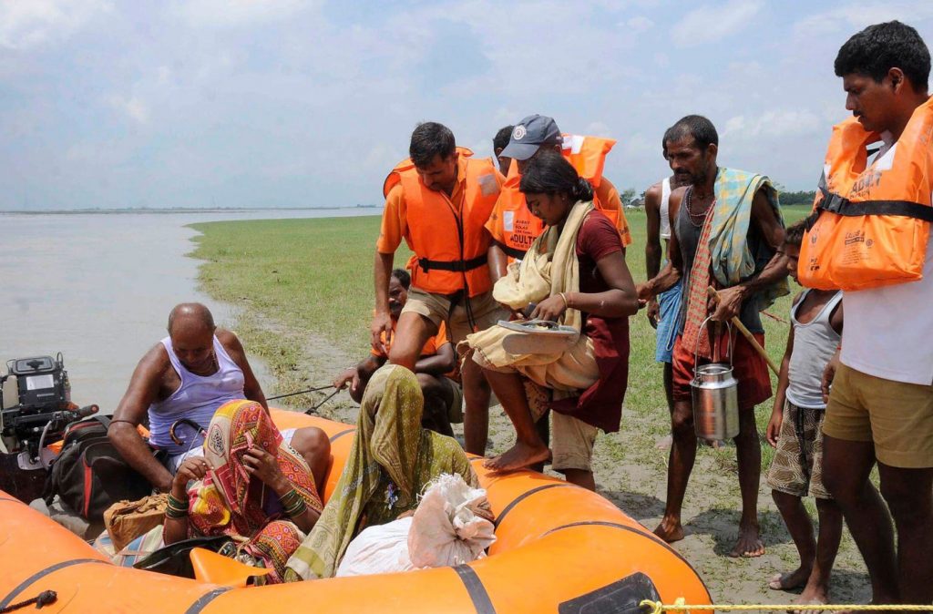 National Disaster Response Force (NDRF) personnel evacuate villagers in the eastern Indian state of Bihar in 2014. After a landslide in Nepal, thousands of people downstream in India were at risk of flooding. Photo: Krishna Murari Kishan / Alamy