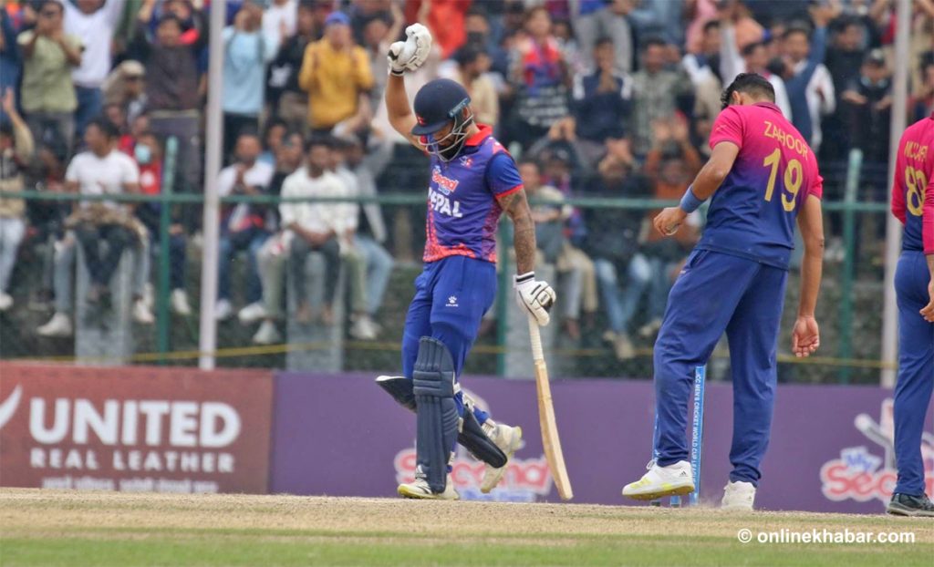 Kushal Bhurtel raises his hand after scoring a half-century against UAE on March 16, 2023. The win in this match resulted in Nepal qualifying for the World Cup Qualifier.