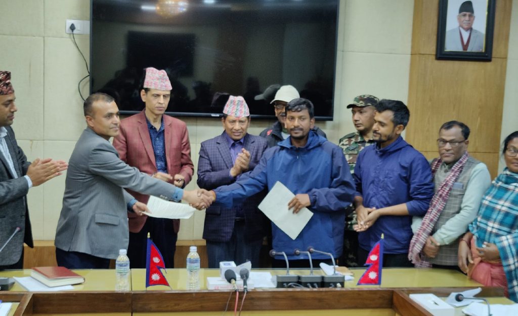 Meterbyaj/loan shark victims sign an agreement with the Ministry of Home Affairs officials, in Kathmandu, on Saturday, April 1, 2023. 