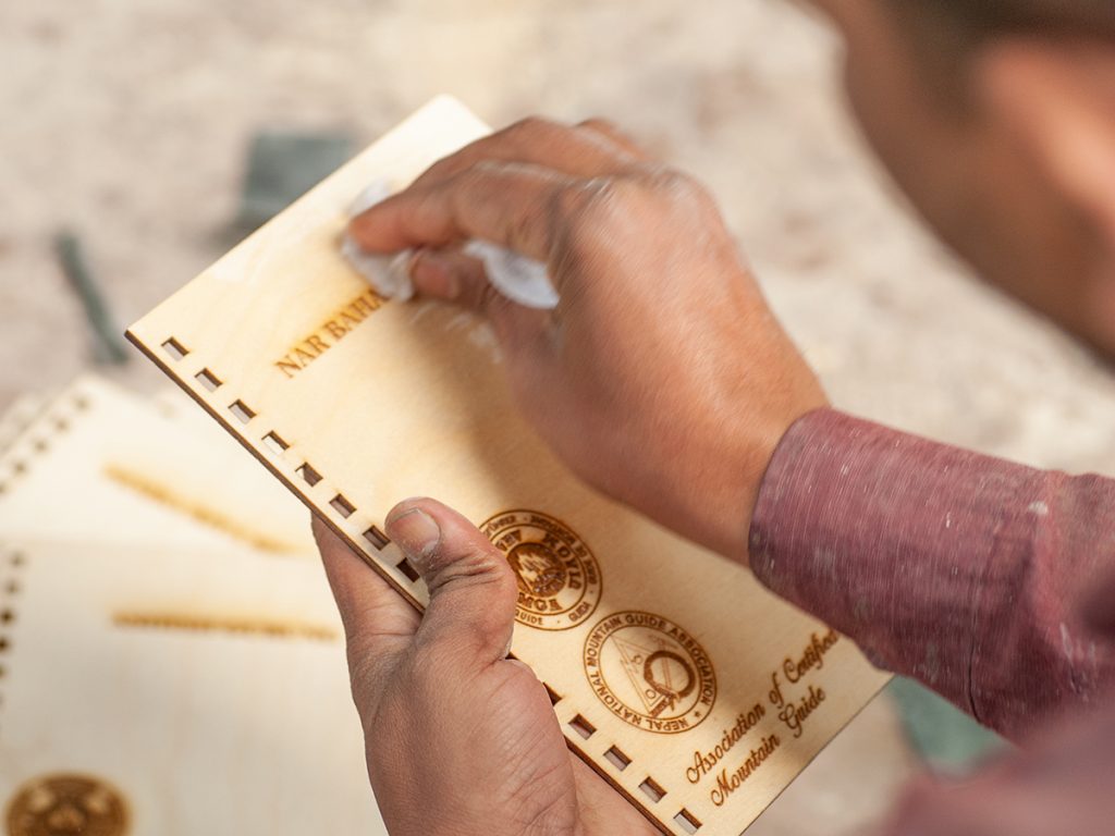 Mastakala-worker-polishing-the-wooden-gift-items