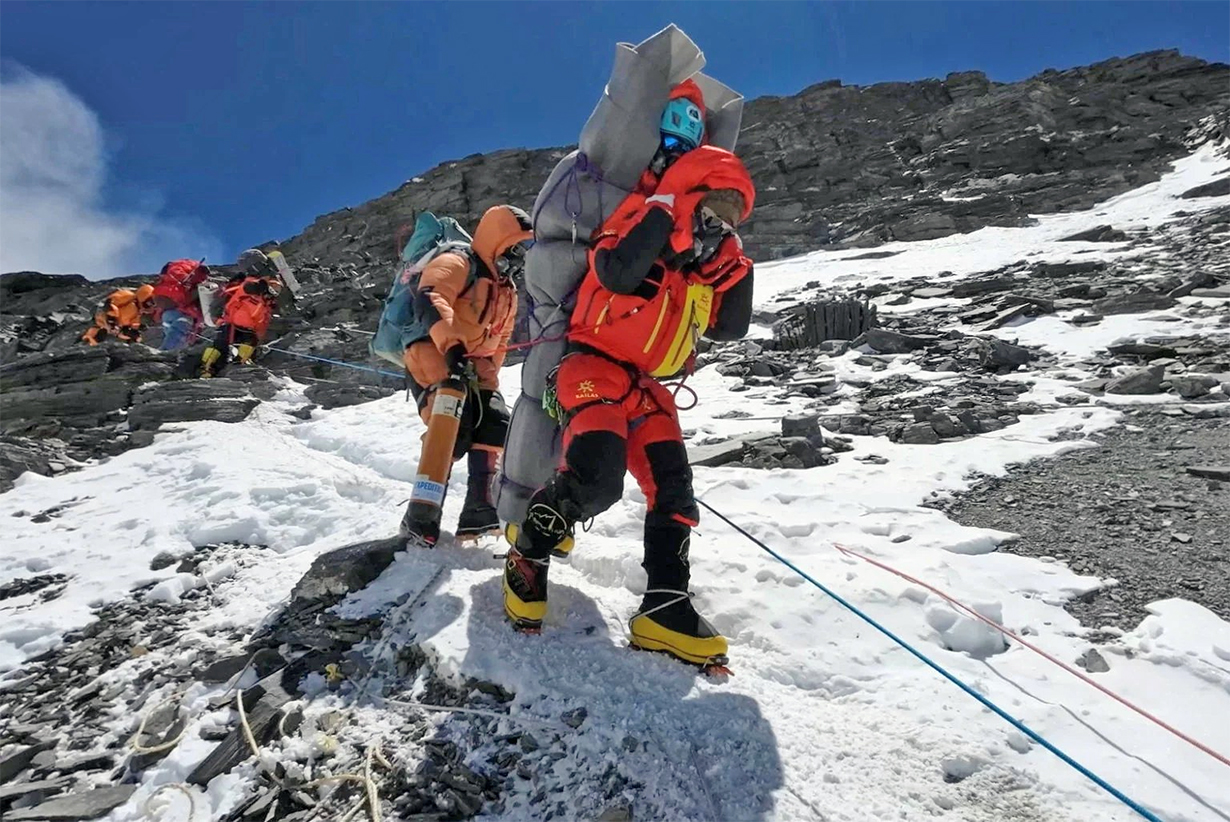A team including Gelji Sherpa and Ngima Tasi Sherpa on their way to base camp after rescuing a Malaysian climber.