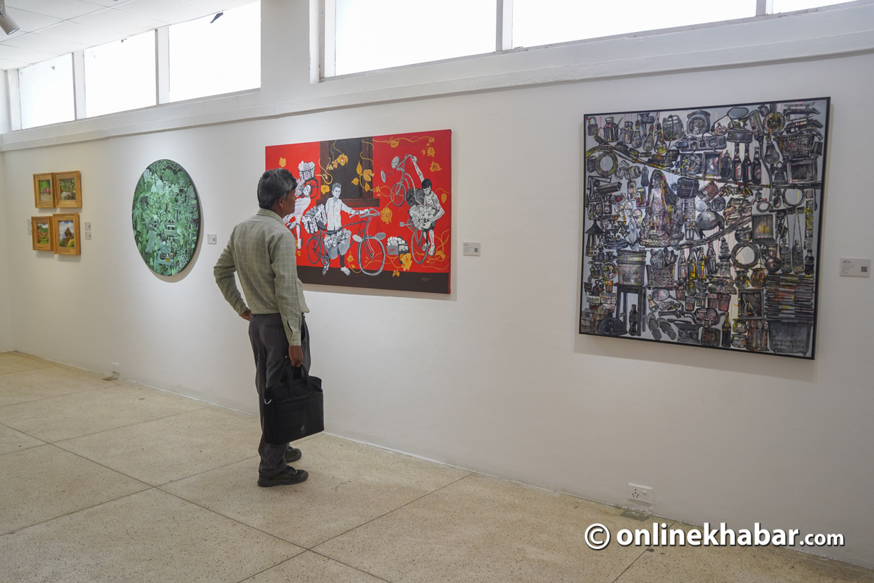 A visitor viewing paintings at Himalayan Art Festival 2023 held at Nepal Art Council, Baber Mahal, Kathmandu. Photo: Chandra Bahadur Ale