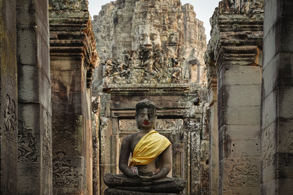 A statue of Buddha in Bayon, a Buddhist Temple in Cambodia. Photo: Pexels/ Neat Chanmanith