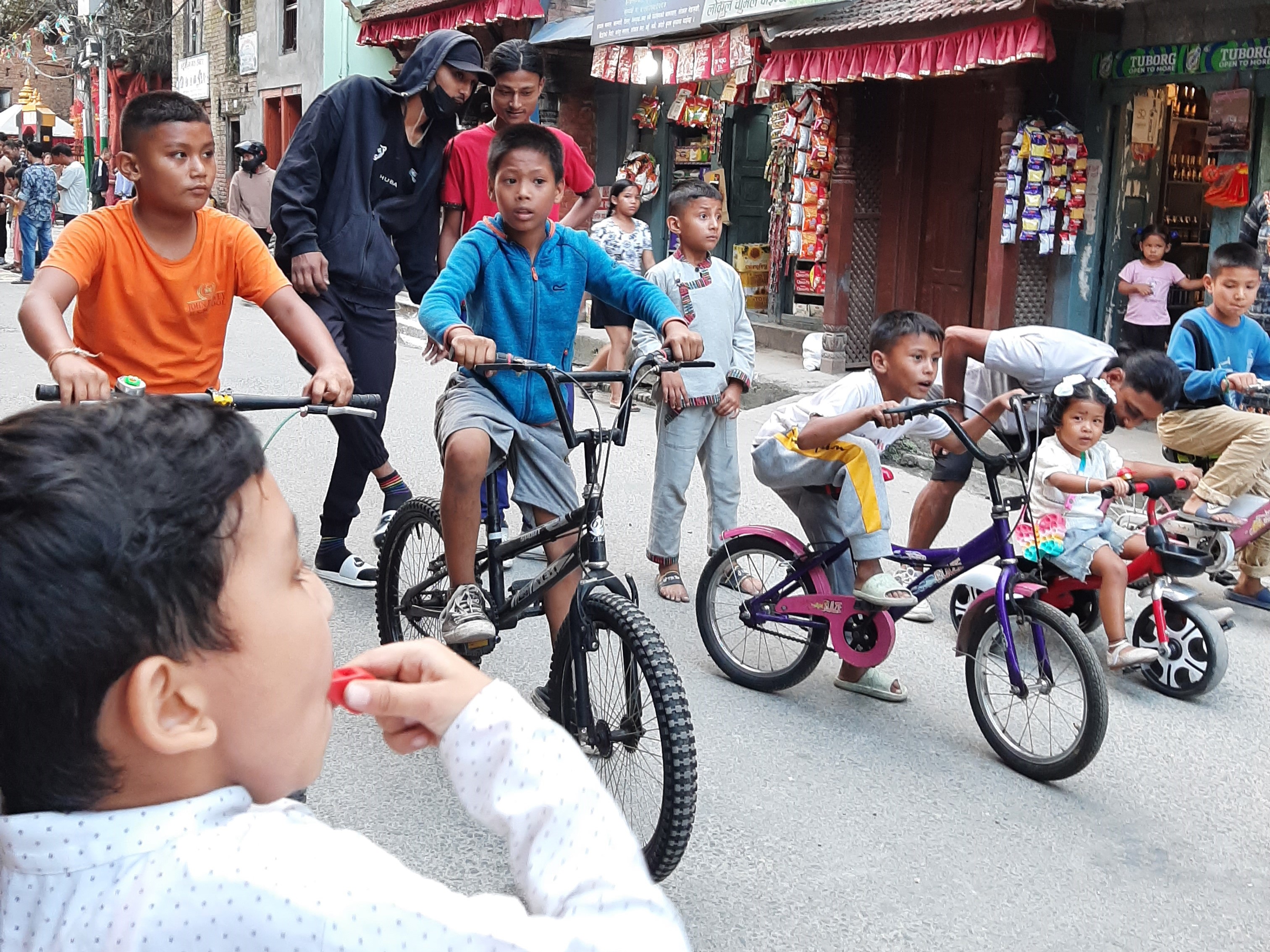 Children racing their cycles on the road on car-free Saturdays in Handigaon. Photo Courtesy: Niharika Mathema