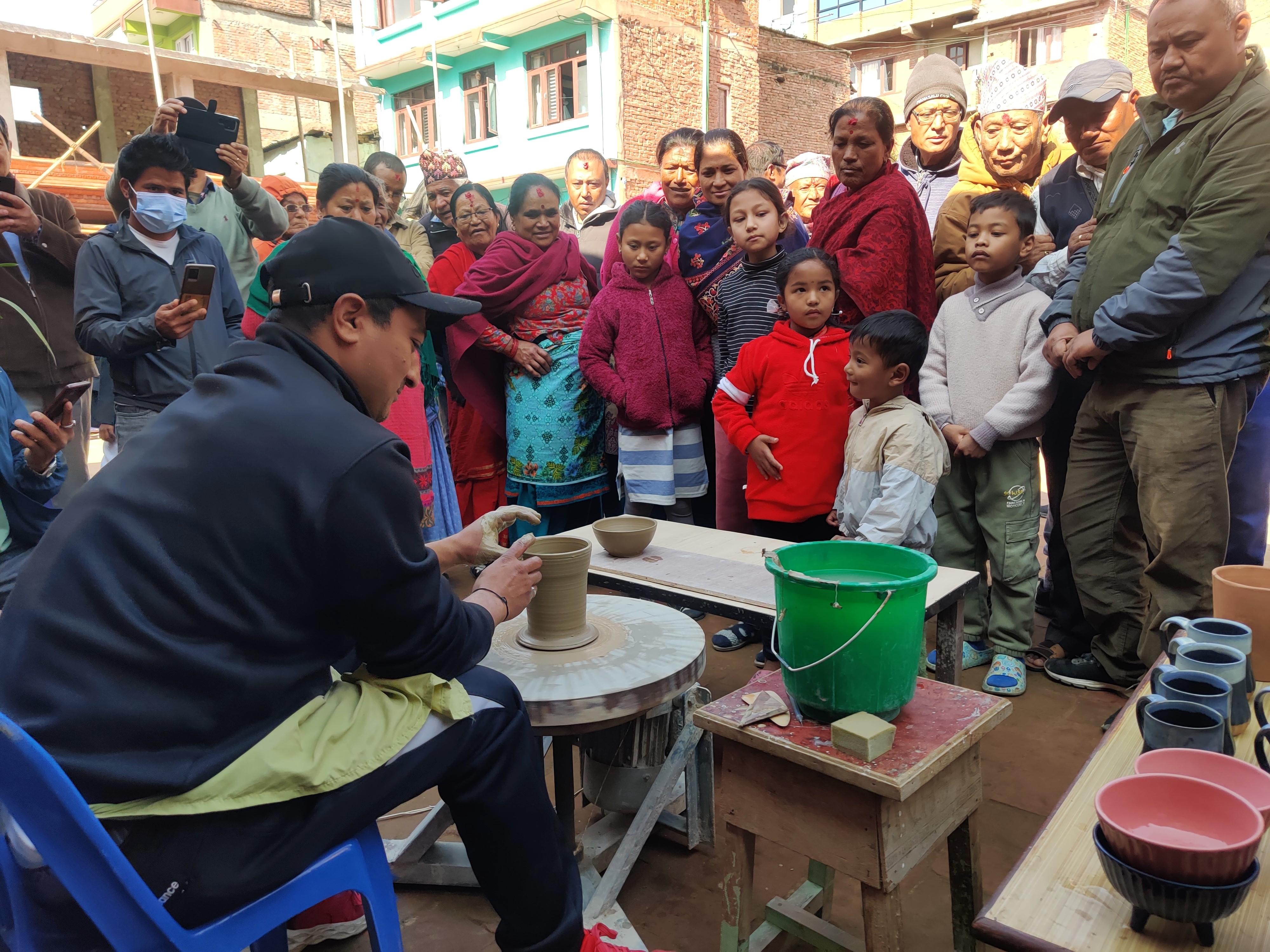Visitors observing the live exhibition of pottery making showcasing the Newa culture during Harisiddhi Art Mela, held on Tuesday, January 2. Photo: Nasana Bajracharya