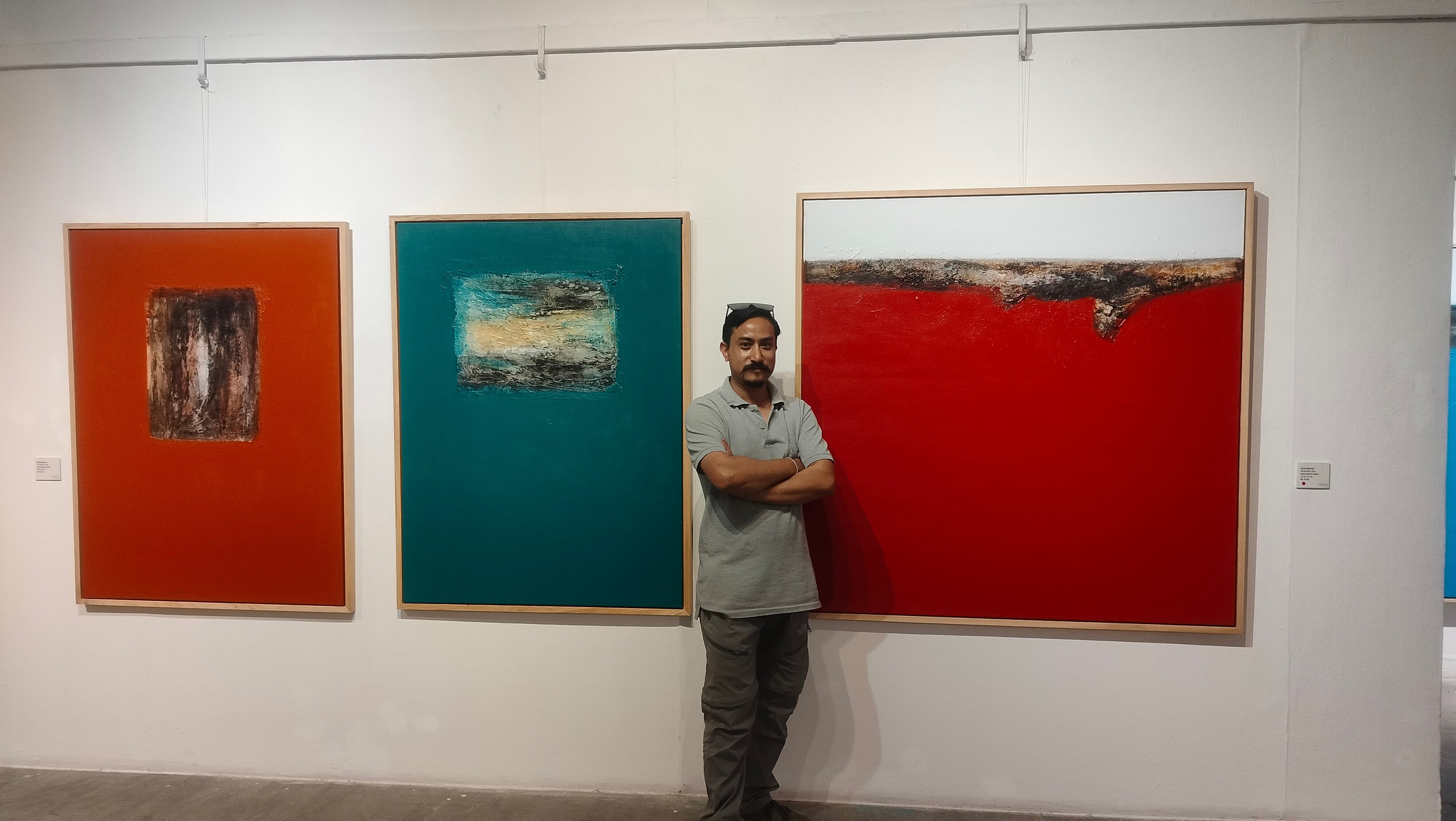 Artist Bijaya Maharjan infront of his painting at Nepal Art Council.