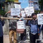 NSU demonstrates in front of Ghantaghar carrying empty gas cylinders
