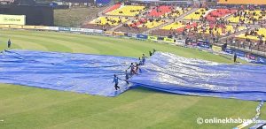 Scattered rain at TU Cricket Ground, field covered